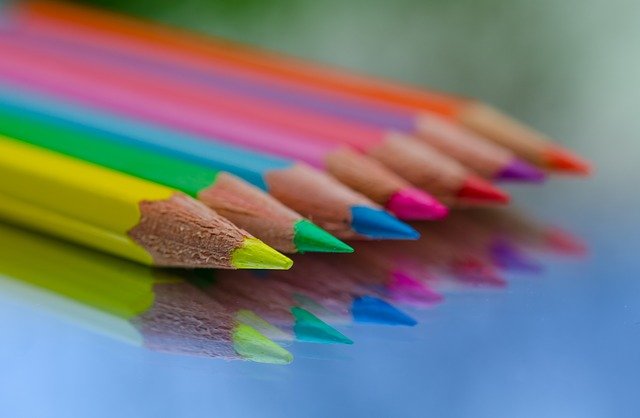 Neon colored pencils in a row with sharpened points