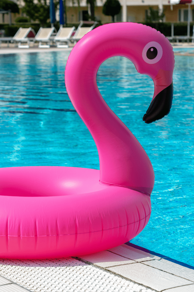pink flamingo floatie on pool deck