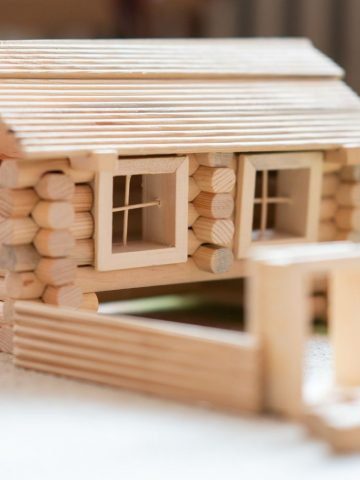 wood building toy shaped into log cabin