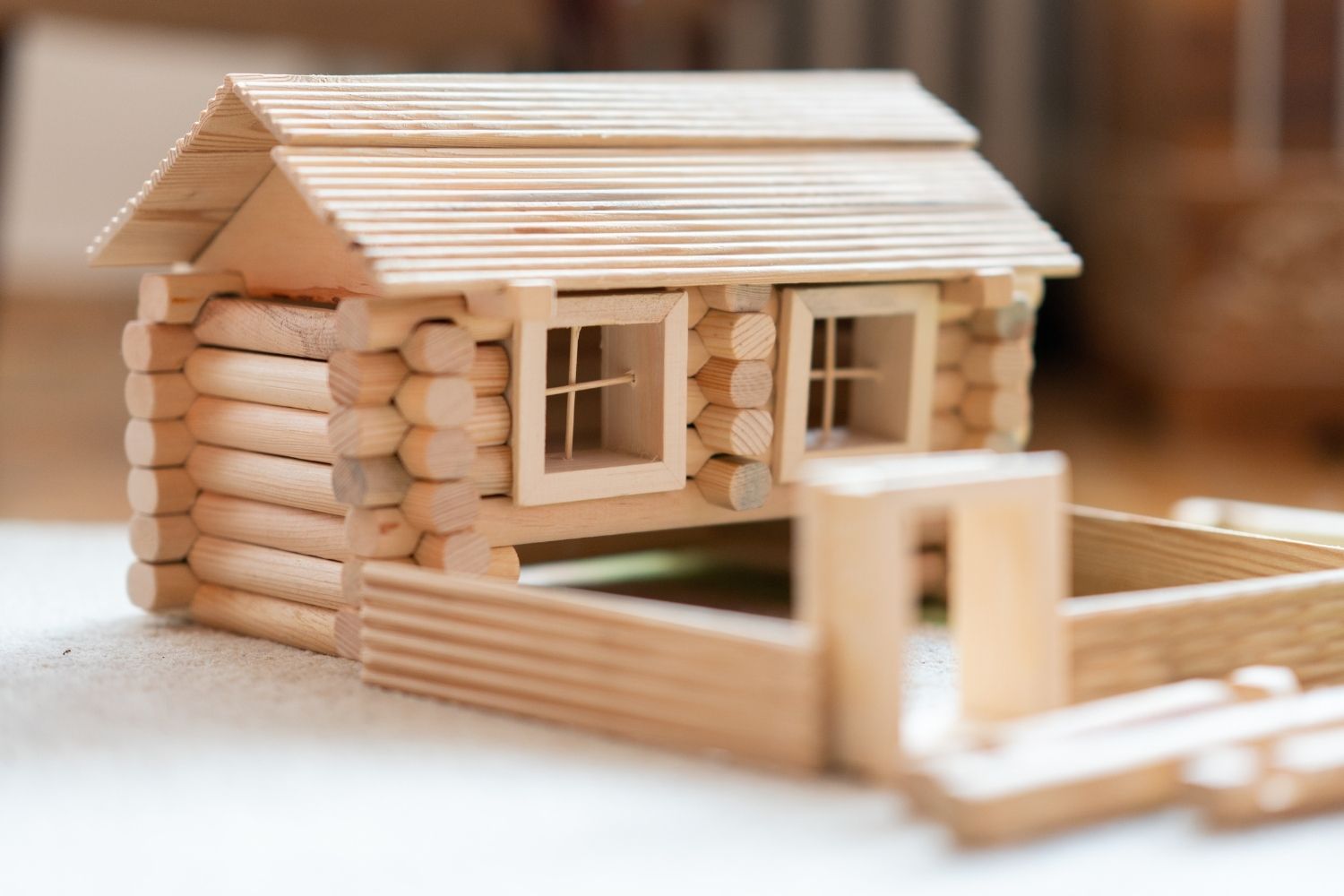 wood building toy shaped into log cabin