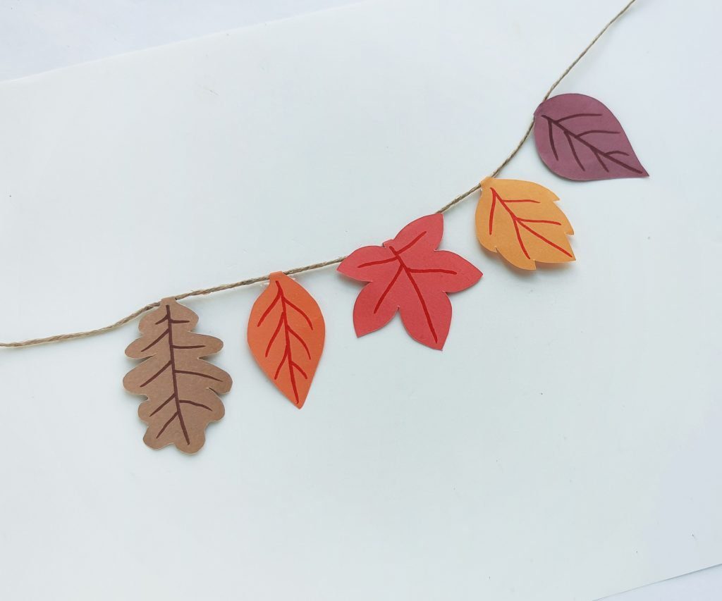 brown yellow and orange leaves on paper fall leaf garland