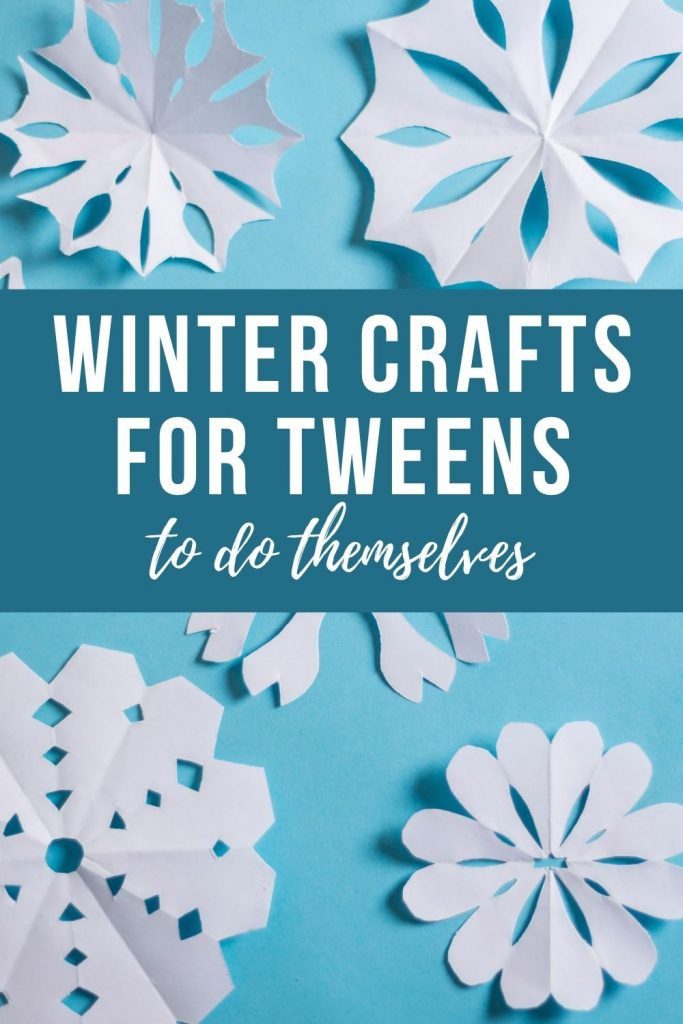 white paper snowflakes on blue background - winter craft projects